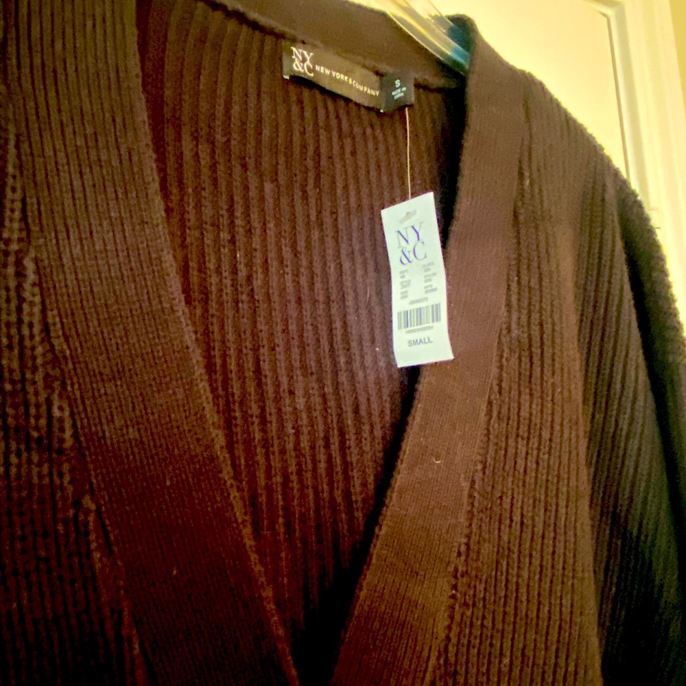 New with tags. Oversized black button up sweater.